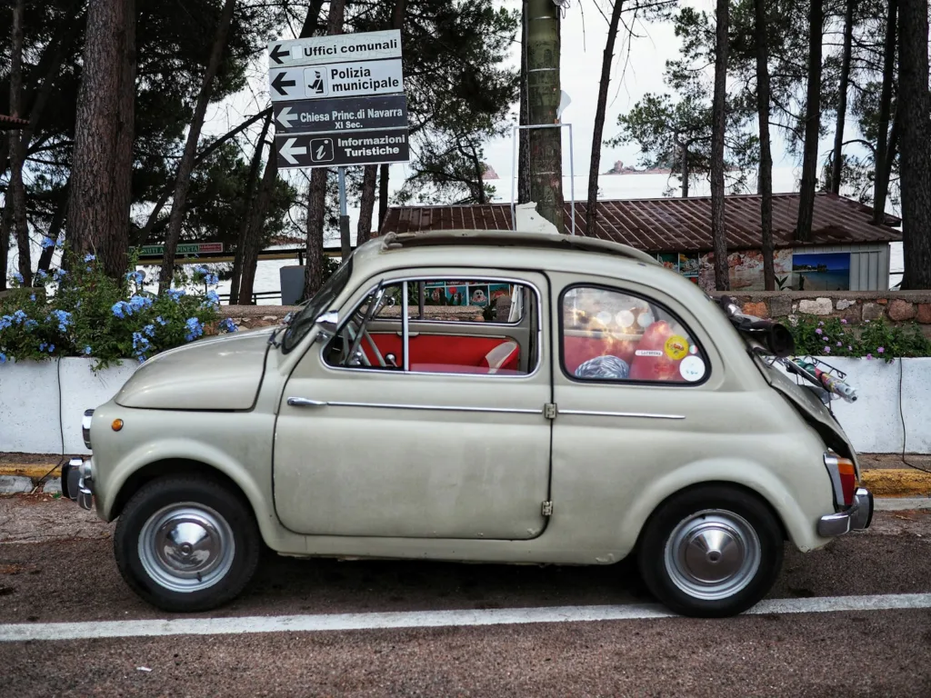 an old car parked on the side of the road