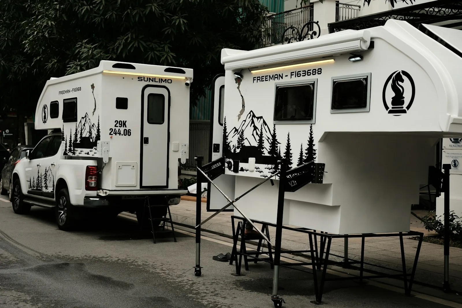 A couple of white trucks parked next to each other